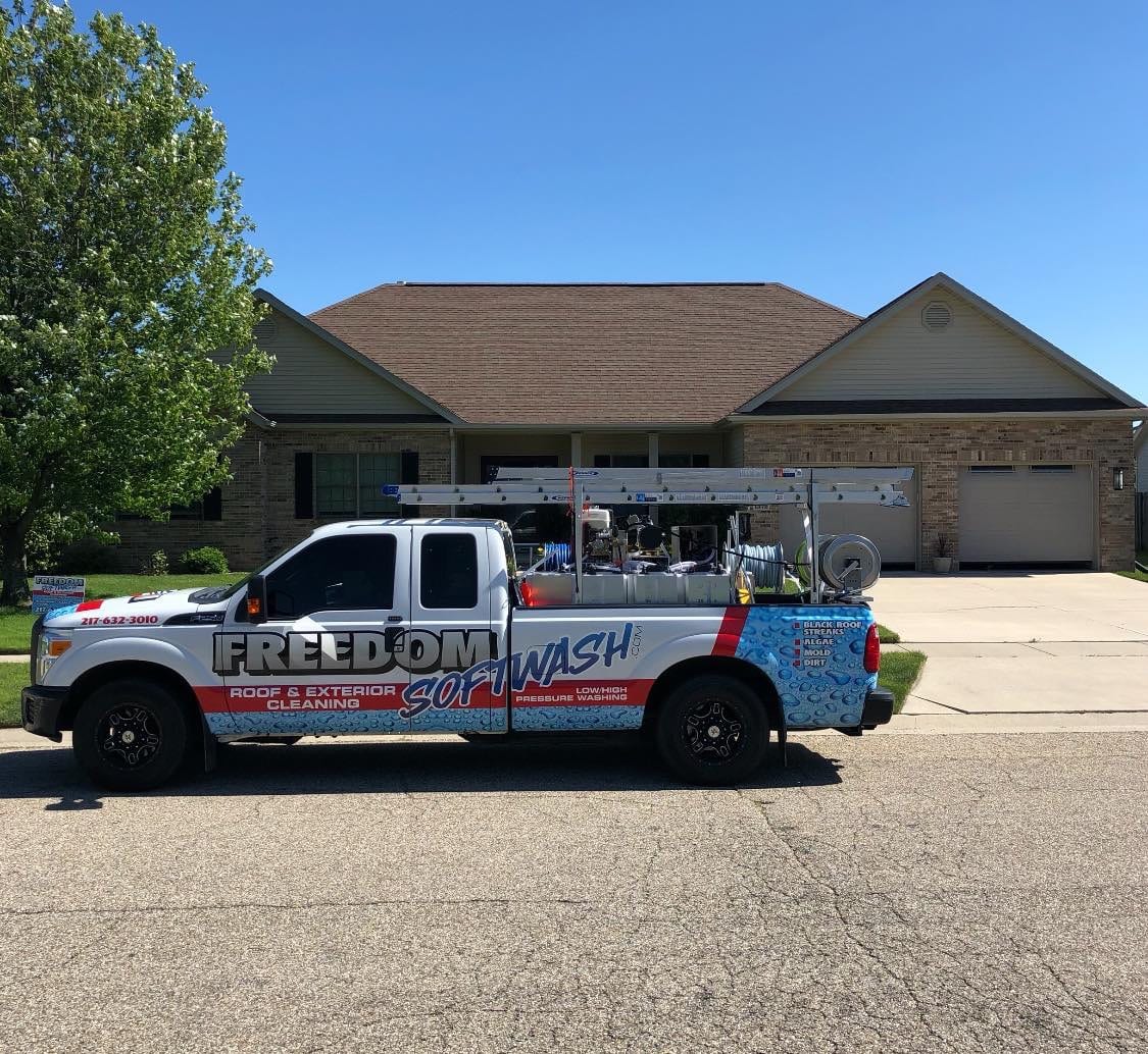 Freedom Softwash is an effective method of cleaning your roof. It’s safe on shingles and maintains the life cycle of your roof. Contact us to schedule a time to have your roof soft washed with our SoftWash Systems biodegradable, non-toxic treatment that prevents new molds, mildews, algae, and mosses from taking up residence for up to 6 times longer than traditional pressure washing services. If you have any questions about the service or the treatments used, contact us today. According to the Asphalt Roofing Manufacturer's Association (ARMA), algae is the number one reason your roof becomes discolored over time. The growth of this fungus roots itself deep within your shingles, and takes much more than a bit of scrubbing to remove entirely. But - ARMA warns that traditional high-pressure washing systems should not be used on your roofing shingles, and for two reasons: High-pressure washing systems can degrade your shingles and shortening their lifespan High-pressure only removes surface level debris and doesn't get at the root of the issue - the algae growth The best aspect of having your roof cleaned by us is the promise of no damage. Our soft washing is performed with little to no pressure, unlike traditional pressure washing that can seriously shorten the life cycle of your roof. SoftWash Systems’ proprietary blend of cleansers kills all mold and mildew, eradicating those green stains and black streaks. The application process won’t damage your shingles or any of the layers beneath. All roofing is delicate and needs to be handled with care. We have dedicated ourselves to not just the removal of these stains, but to understanding what it is, why it develops, and how best to remove it without damaging any surfaces or structures. By using our soft wash service, these contaminants are removed properly and won’t return for up to six times longer than traditional pressure washing. IF YOU'D LIKE TO SEE WH